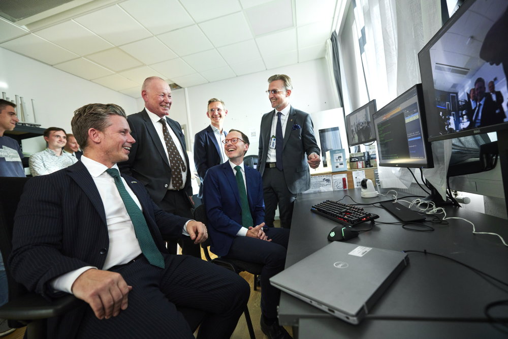 Men sitting around computer, talking