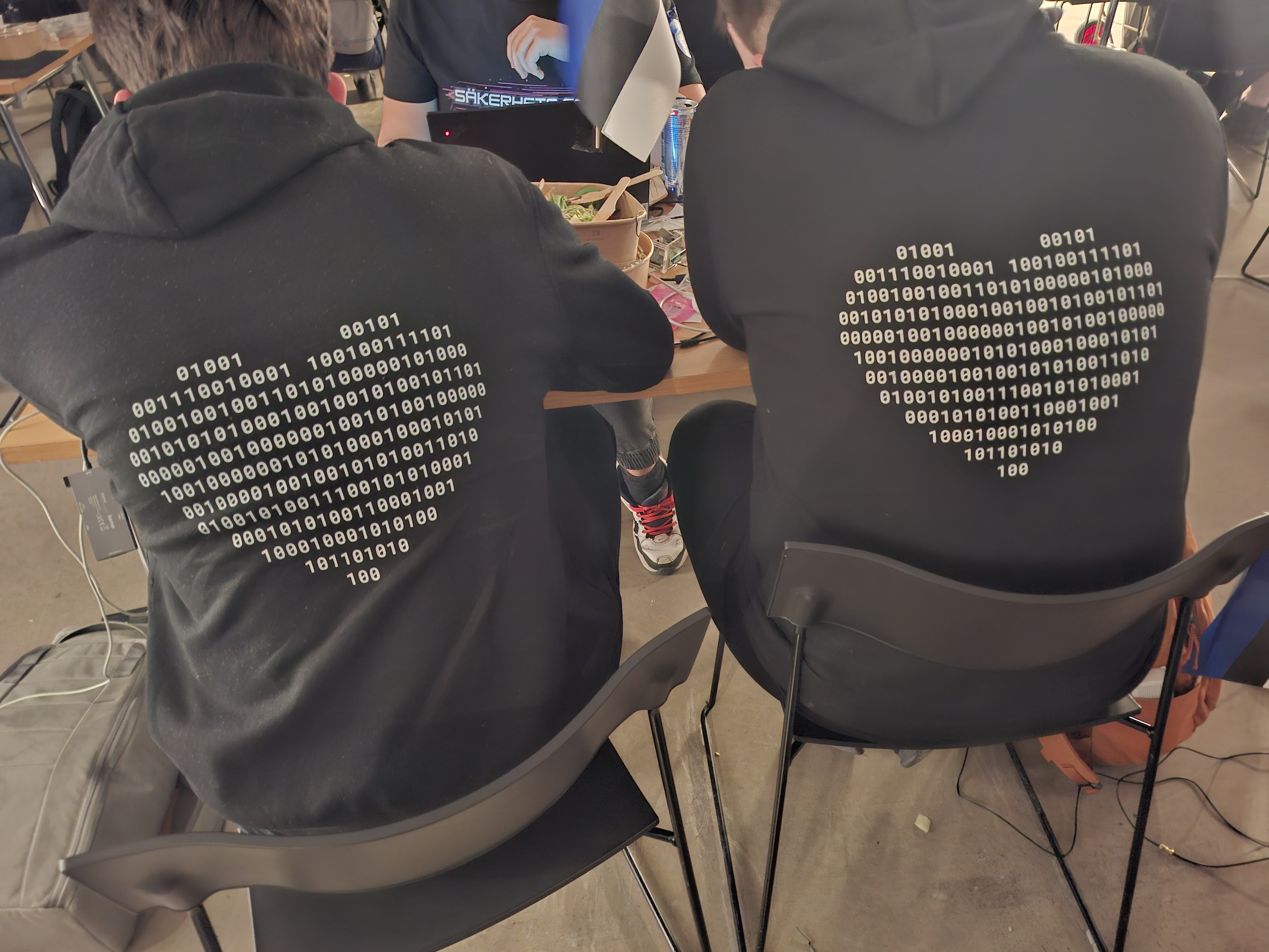 Two young people by a computer.